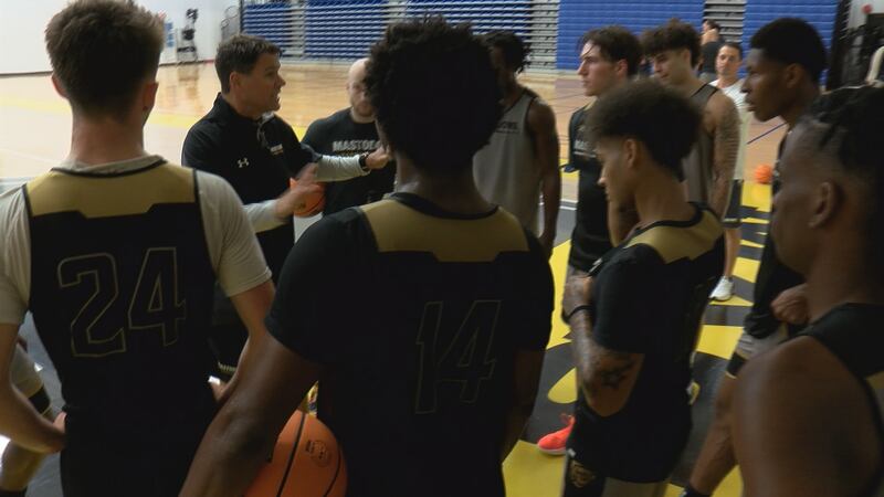 Head Coach Jon Coffman talks with the Purdue Fort Wayne men's basketball team during a...
