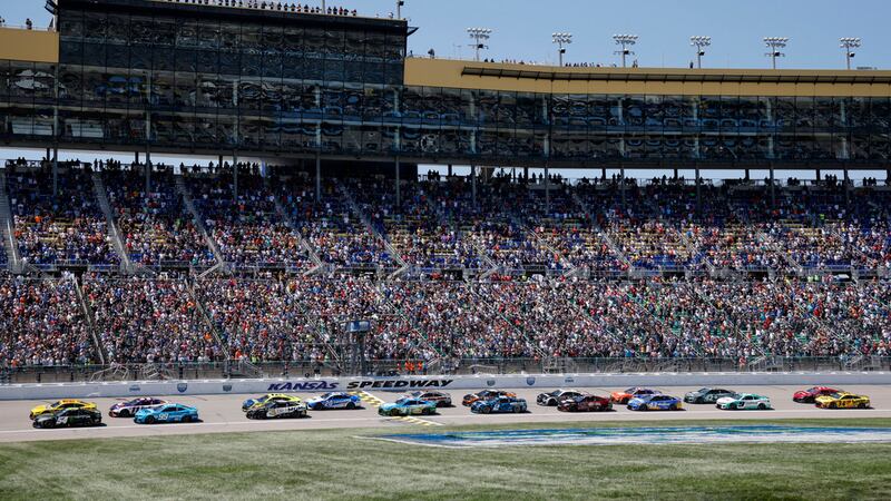 Drivers head down the front straightaway at the start of a NASCAR Cup Series auto race at...