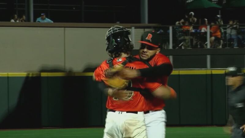 Dayton pitcher Jayvien Sandridge hugs catcher Michael Trautwein after recording the final out...