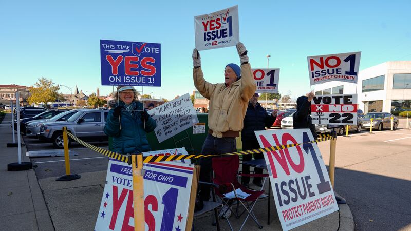 People gather in the parking lot of the Hamilton County Board of Elections as people arrive...