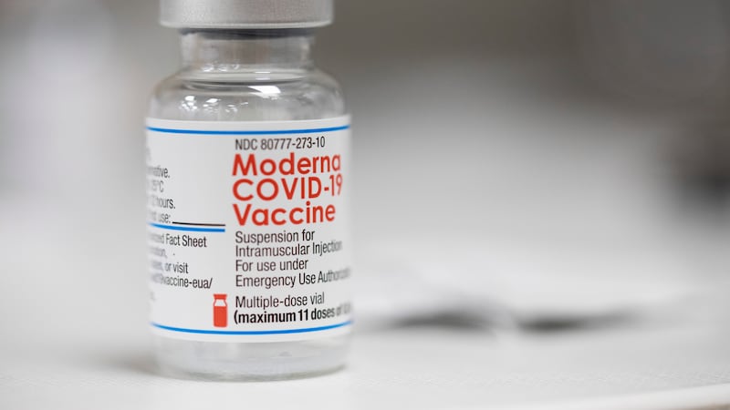 A vial of the Moderna COVID-19 vaccine is displayed on a counter at a pharmacy in Portland,...